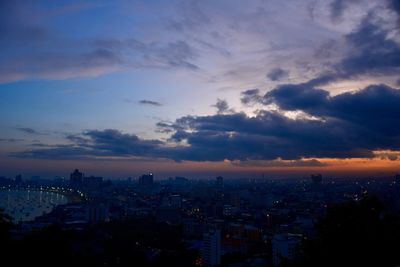 High angle view of illuminated buildings against sky at sunset