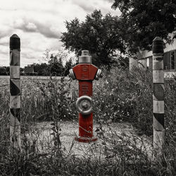 Red fire hydrant on field against sky