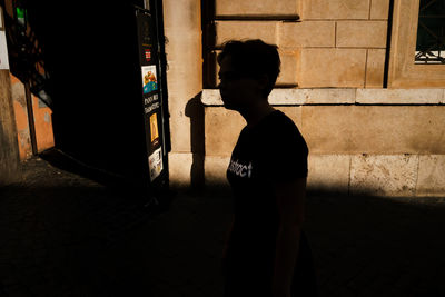 Silhouette man standing on street at night