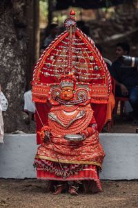 Close-up of red temple against building