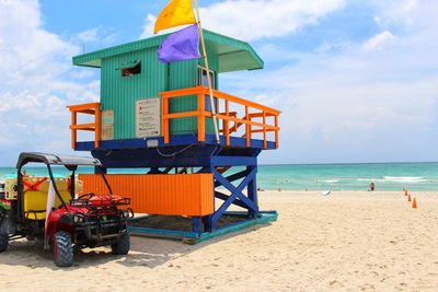 Lifeguard hut on beach against sky