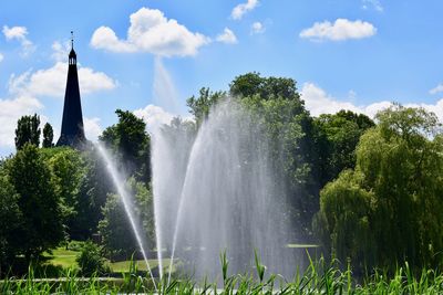 Water splashing in fountain against sky