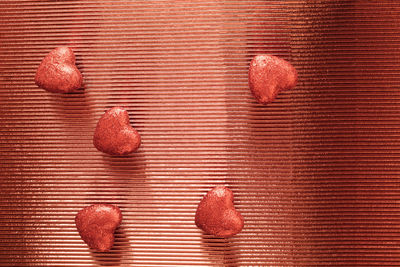 Red glitter hearts on shiny background. anniversary and valentine's day concept. copy space