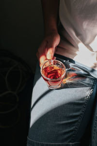 Midsection of man holding glass