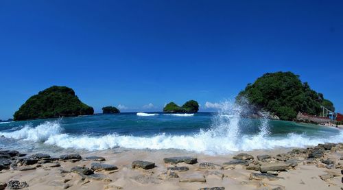 Scenic view of sea against clear blue sky