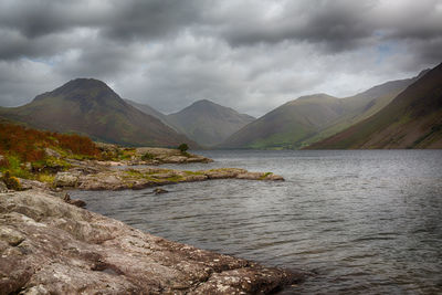 Scenic view of lake and mountains against sky