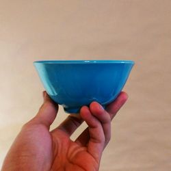 Close-up of hand holding blue cup