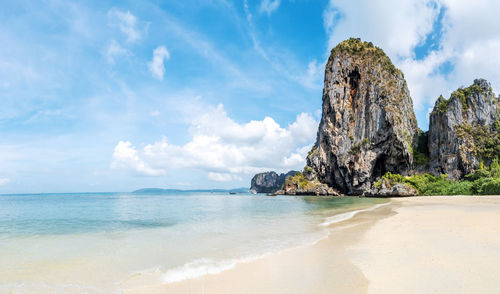 Panoramic view of rocks on beach against sky