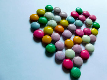 High angle view of colorful candies against white background