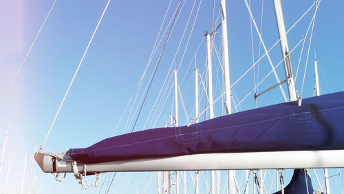 Boom ends and sailsboats masts angle view with sunlight area