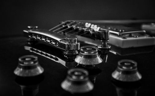 Close-up of guitar over black background