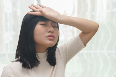 Young woman suffering from headache