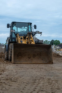 Construction site by road against sky