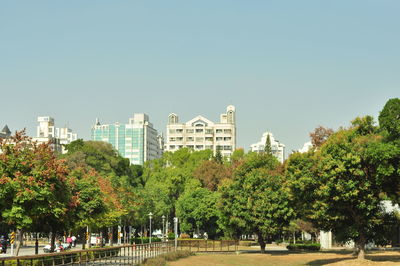 Buildings in city against clear sky