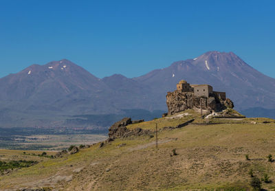 Built structure on mountain against blue sky