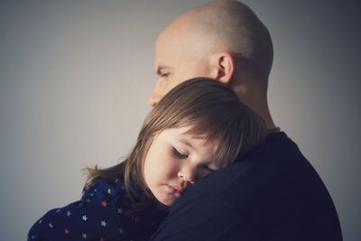 Man carrying sleeping girl