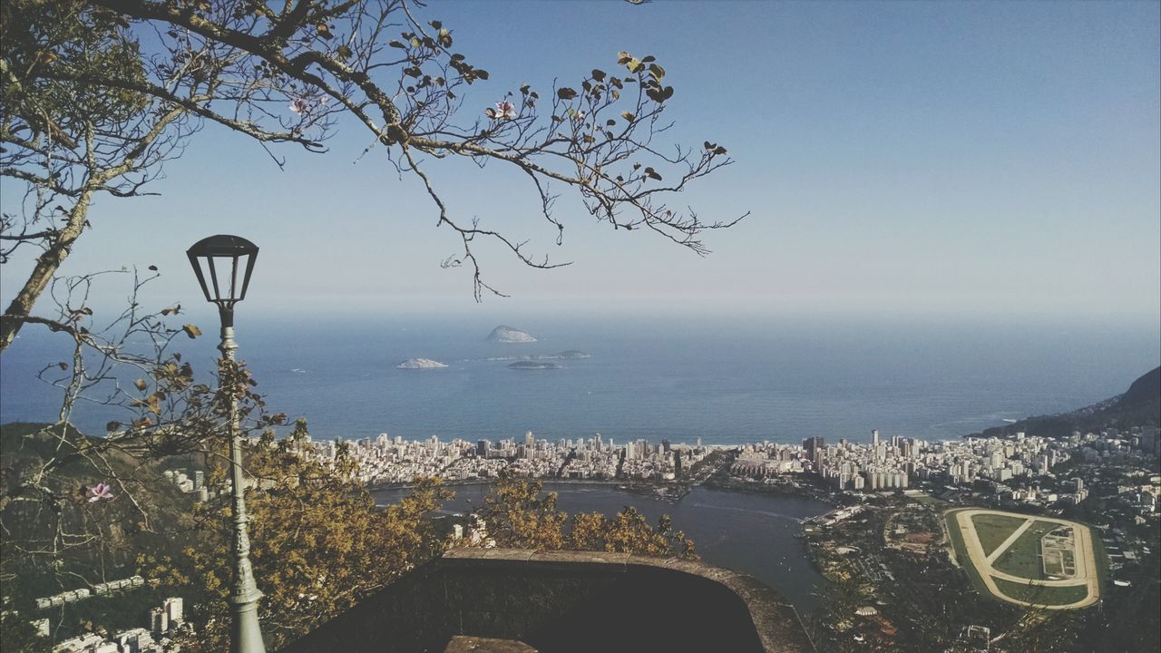 sea, water, horizon over water, sky, built structure, architecture, nature, scenics, tree, building exterior, beauty in nature, high angle view, city, tranquility, outdoors, day, no people, transportation, cloud - sky, tranquil scene