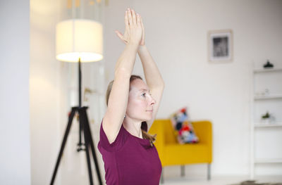 Midsection of woman standing at home