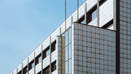 Low angle view of modern building against clear blue sky