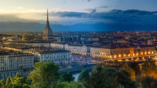 High angle view of buildings against cloudy sky