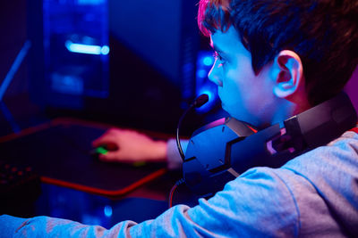 Boy plays computer game at home, gaming addiction
