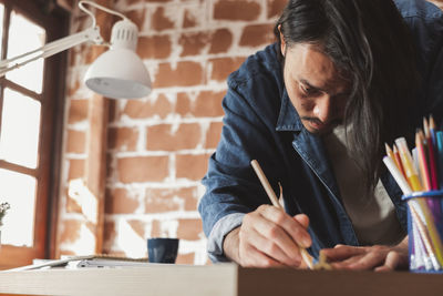 Midsection of man working at home