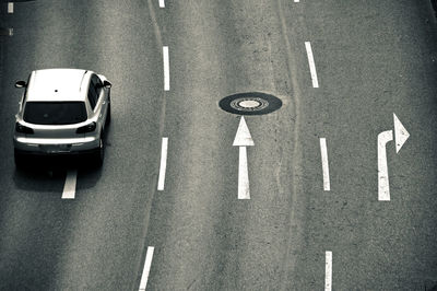 High angle view of car by road sign on street