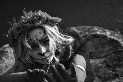 Closeup portrait of calavera catrina. black and white photo. young woman with sugar skull makeup. 