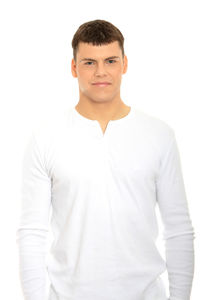 Portrait of young man standing against white background