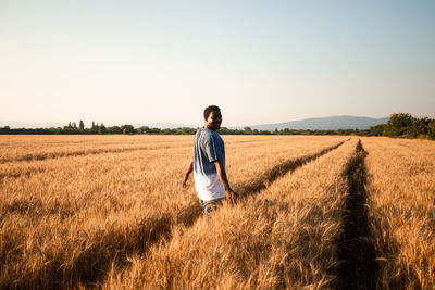 Full length of man standing in field