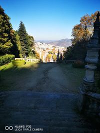 View of footpath by buildings against sky