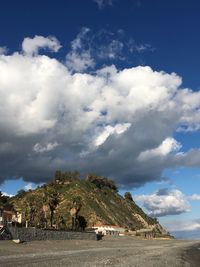 Scenic view of landscape against cloudy sky