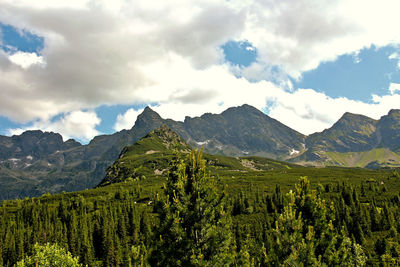 Scenic view of mountains against cloudy sky