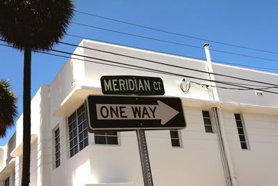 Low angle view of road sign against building