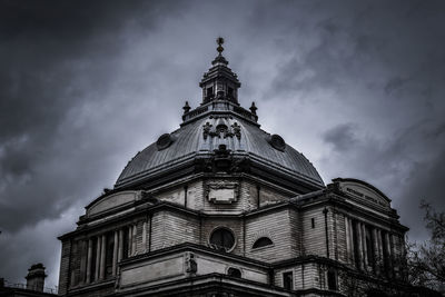 Low angle view of historic building against cloudy sky at dusk