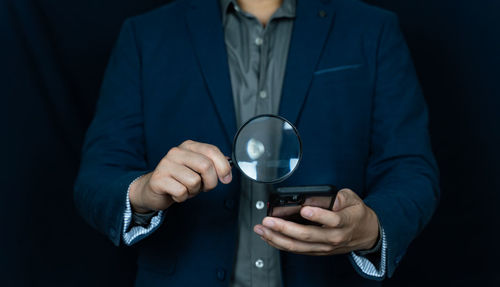 Midsection of man holding crystal ball