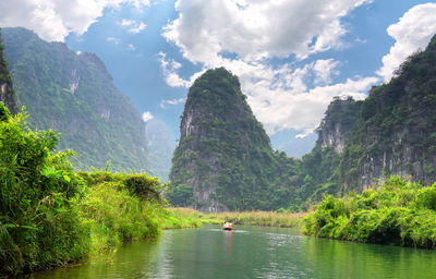 Scenic view of lake and mountains against sky