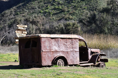 View of abandoned vehicle on field