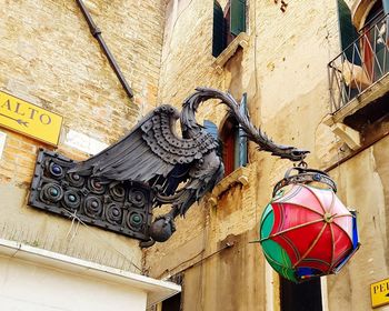 Low angle view of lanterns hanging on old building