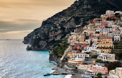 Scenic view of sea with town in background