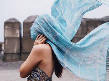 Side view of woman veiled face while standing on street