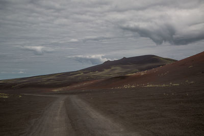 Empty road along countryside landscape