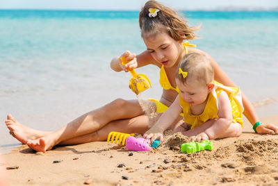 Girls playing with toy at beach