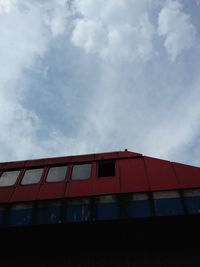 Low angle view of building against cloudy sky