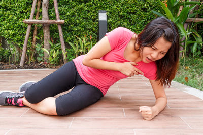 Woman with arms raised on floor