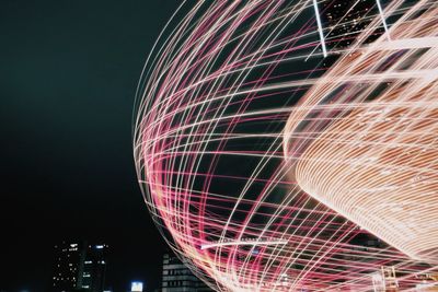 Low angle view of illuminated ferris wheel