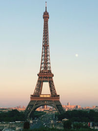 Tower in city against sky during sunset