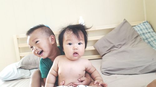 Close-up of cute baby on bed at home
