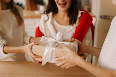 Exchange of christmas gift boxes in december during the winter holiday at home