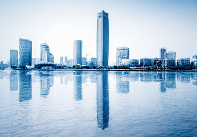 Modern buildings in city against clear sky